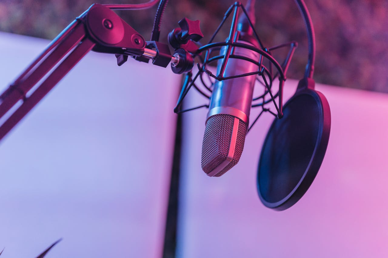 our-journey-02 A close-up view of a microphone in a vibrant studio environment, ideal for podcasts and voice recording.
